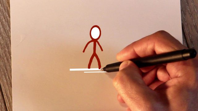 Hand zeichnet ein Strichmännchen für ein animiertes Weihnachtsvideo mit festlicher Beleuchtung